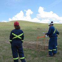 Energy workers doing land survey